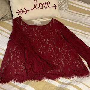 Lace blouse with flared sleeves.